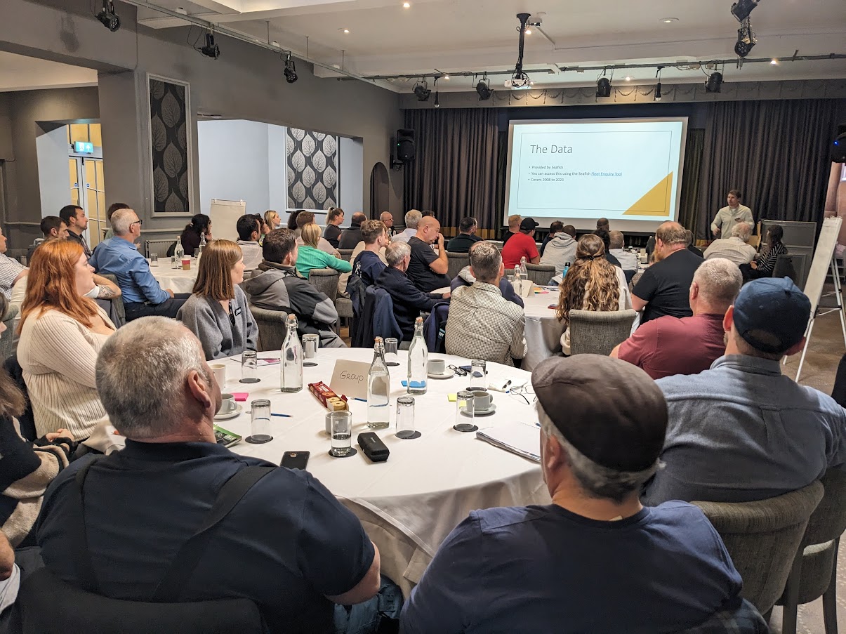 Participants around tables at a workshop