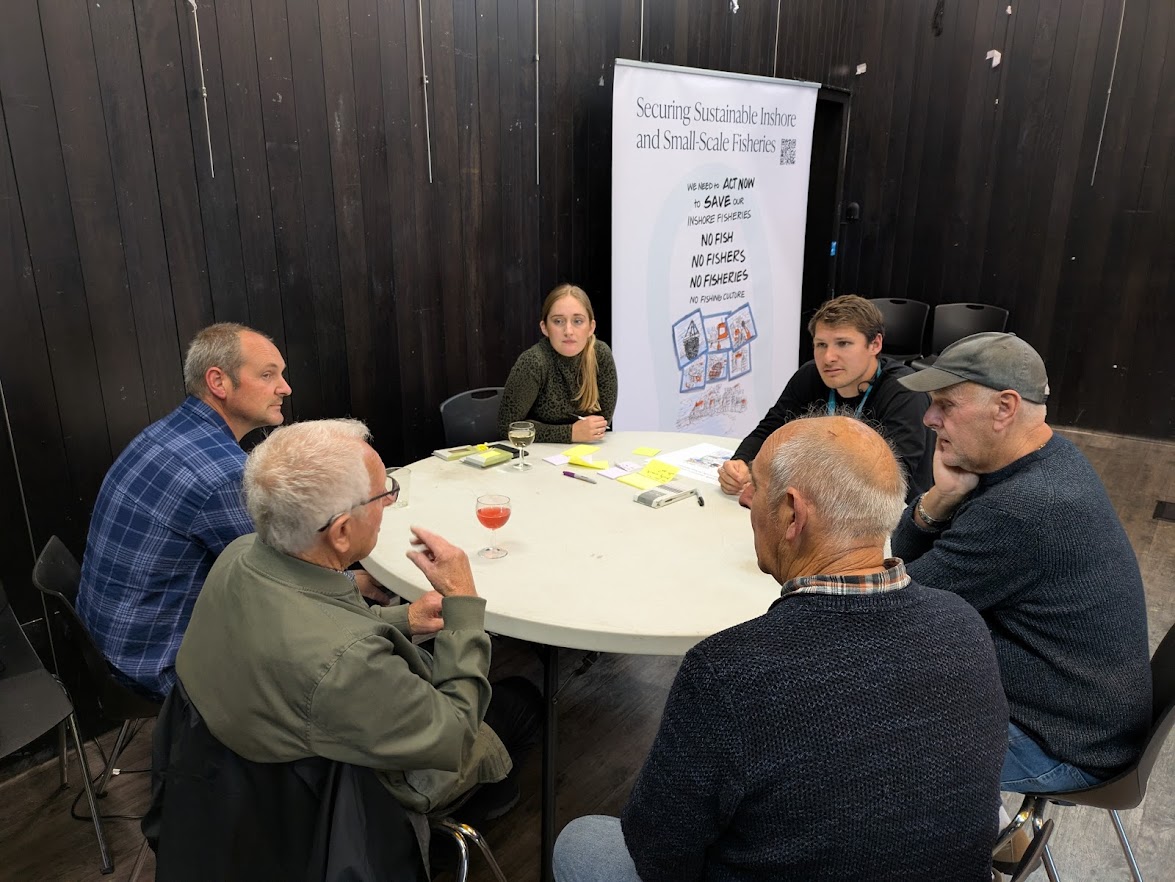 Fishermen discuss issues around a table